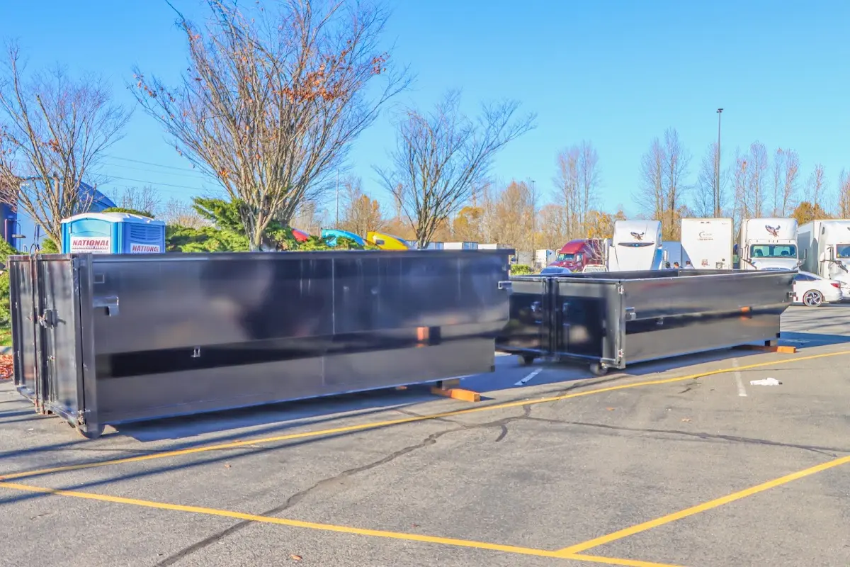 Professional dumpster rental service with roll-off container on residential driveway in Mankato